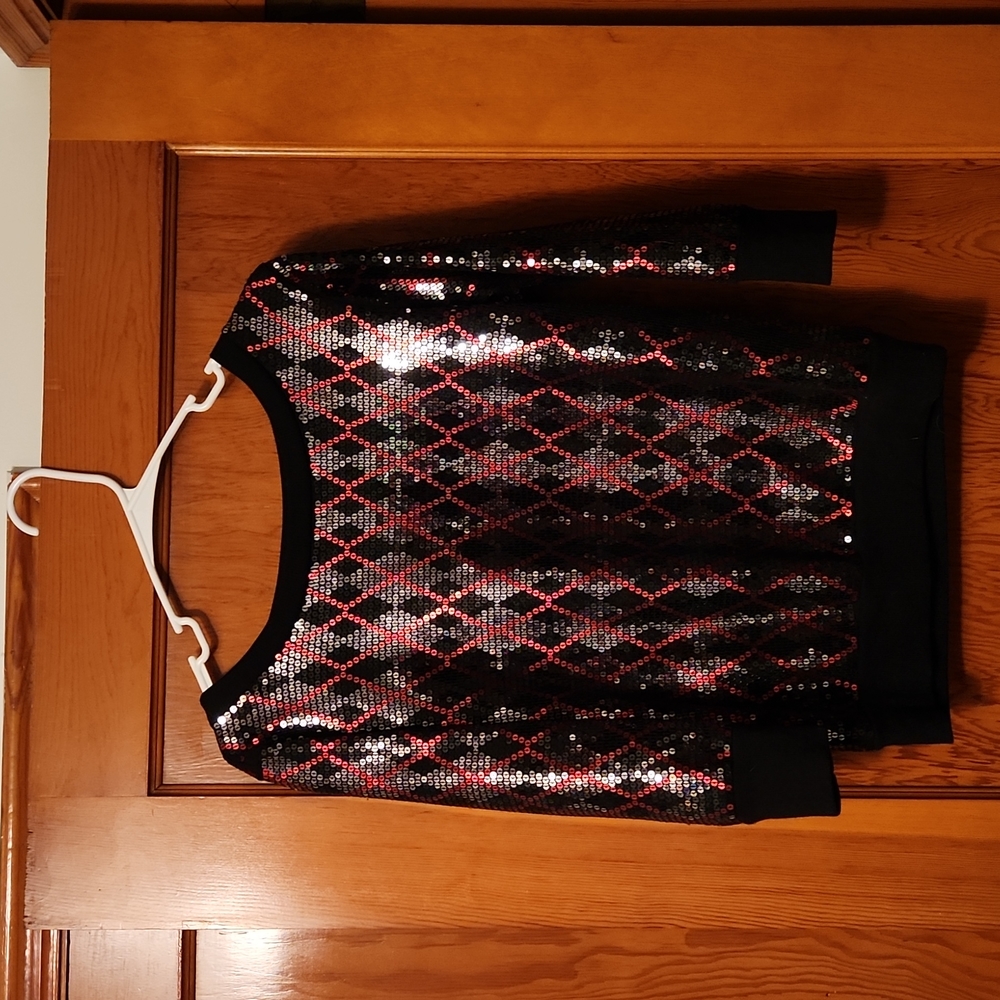 Sequined dress shirt with elbow length sleeves, gently worn.